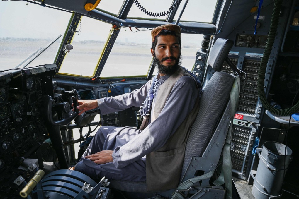 A Taliban fighter sits in the cockpit of an Afghan Air Force aircraft after the US pulled its troops out of the country. Photo: AFP