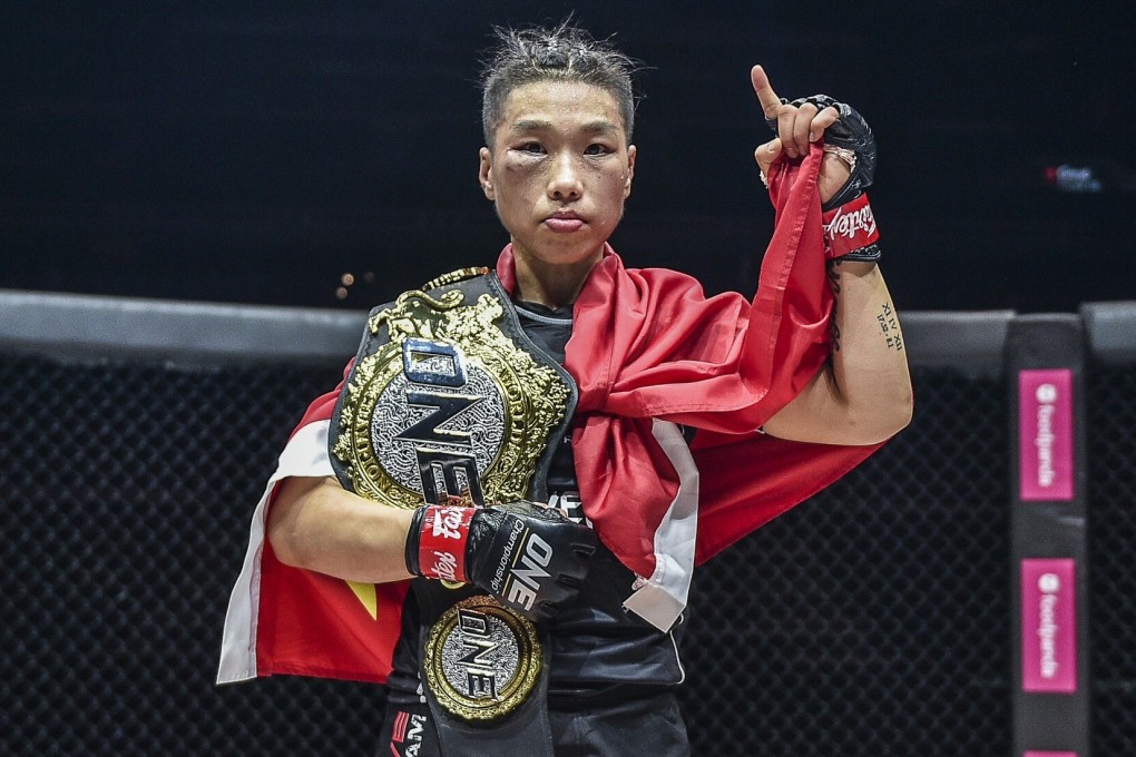 Xiong Jingnan celebrates with her strawweight title after beating Tiffany Teo by unanimous decision. Photos: ONE Championship