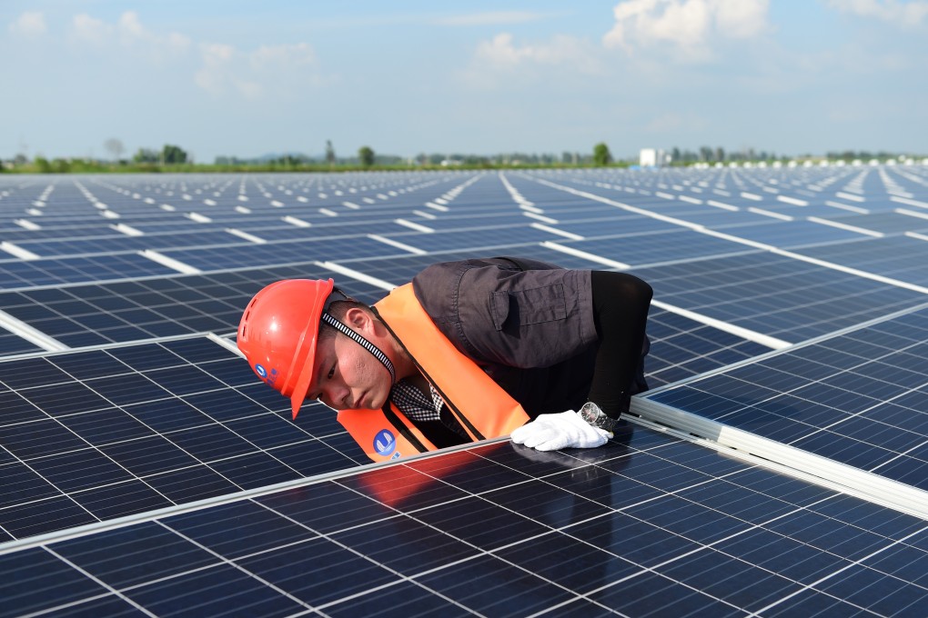 An engineer conducts maintenance work at a floating solar farm in China’s Anhui province. Photo: Xinhua