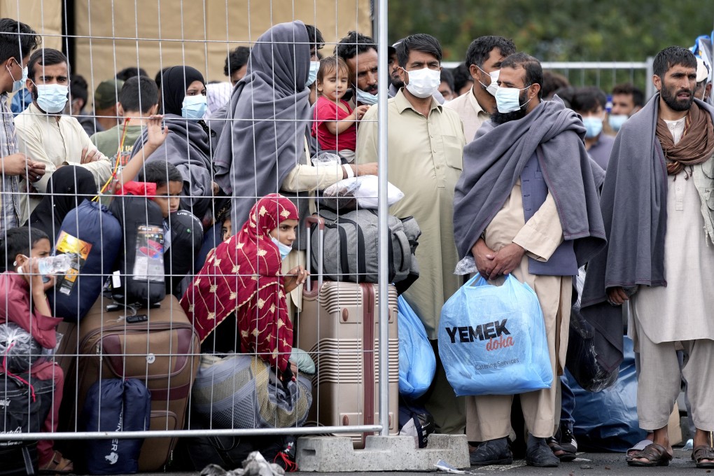 People stay next to a fence at the Ramstein US Air Base in Ramstein, Germany, on August 30. Photo: AP