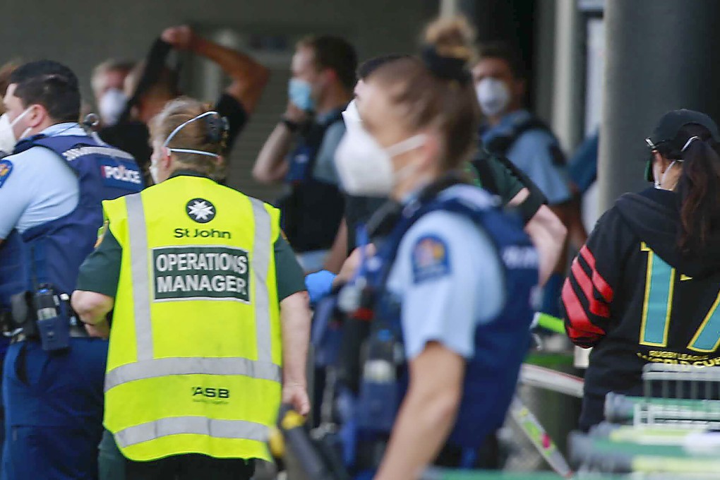 Police and ambulance staff pictured outside the Auckland supermarket where a violent extremist stabbed and injured six shoppers on Friday. Photo: New Zealand Herald via AP