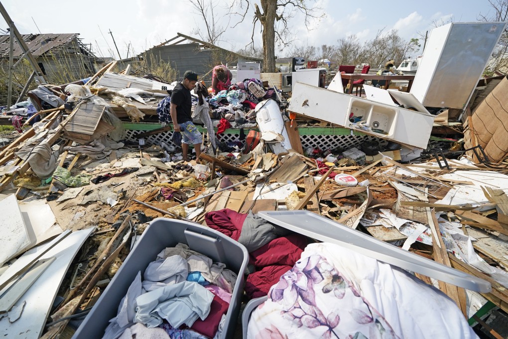 A man helps his mother sift through what remains of her home in the aftermath of Hurricane Ida in Golden Meadow, Louisiana. Photo: AP