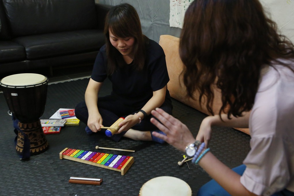 Kristy (left) demonstrates art therapy at Cattle Depot Artists Village in Ma Tau Kok. Photo: Edmond So
