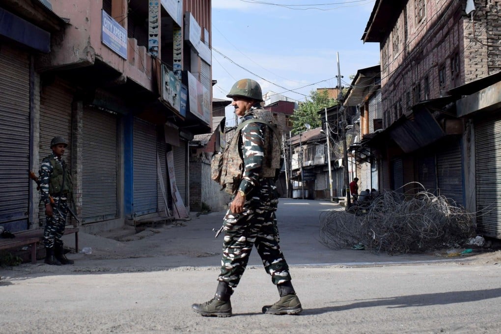 Indian security forces patrol in front of closed shops in Srinagar after restrictions were imposed following the death of a separatist leader. Kashmir has seen an uptick in violence in the last three months. Photo: Reuters