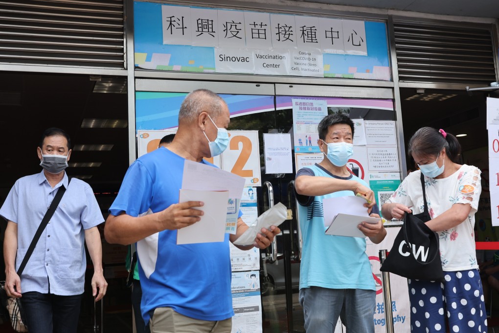 People queue for their coronavirus jabs at Kowloon Bay Sports Centre. Photo: May Tse