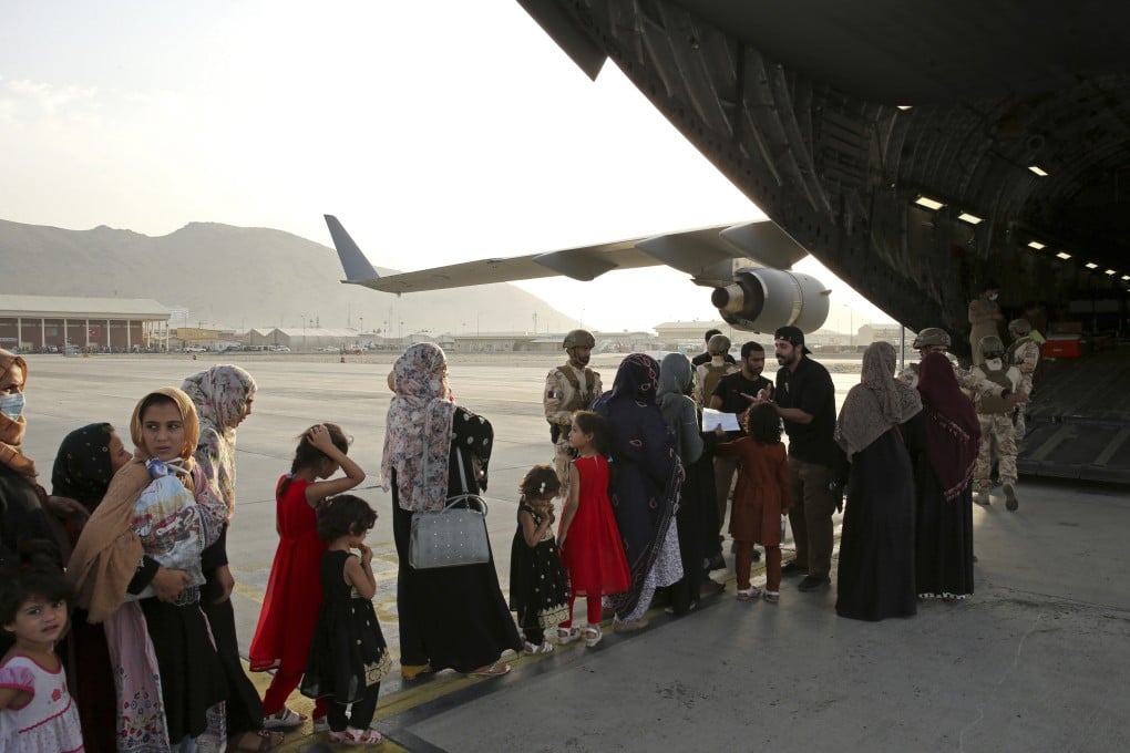 Afghans being evacuated aboard a Qatari transport plane, at Hamid Karzai International Airport in Kabul, Afghanistan, last month. Qatar has played a large role in US efforts to evacuate tens of thousands of people from Afghanistan. Photo: AP