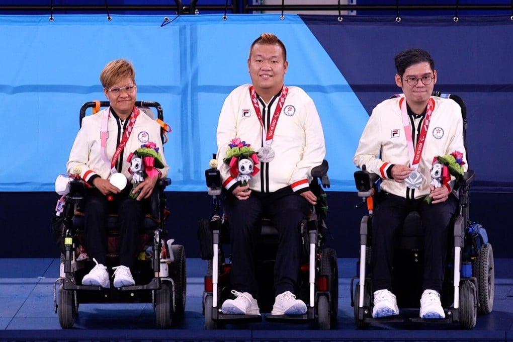 Hong Kong's Vivian Lau, Leung Yuk-wing and reserve player Raymond Wong celebrate on the podium after winning silver in the mixed pair BC4 event at the Tokyo Paralympics. Photo: Hong Kong Paralympic Association