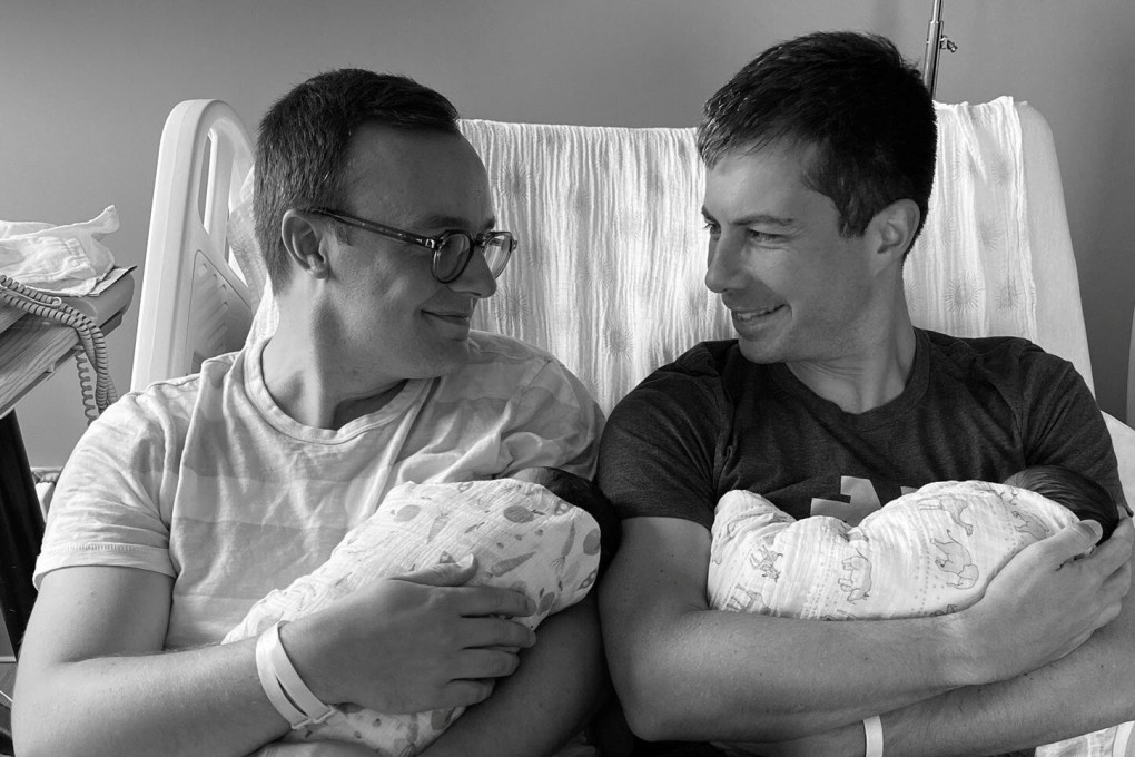 US transport secretary Pete Buttigieg, right, and his husband Chasten introduce their two babies, Penelope Rose and Joseph August on Saturday. Photo: Twitter/@peterbuttigieg via Reuters