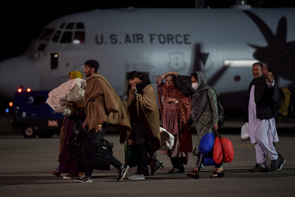 Afghan refugees, fleeing the Afghan capital Kabul, exit a US air force plane upon their arrival at Pristina International airport in Kosovo on August 29. Photo: AFP