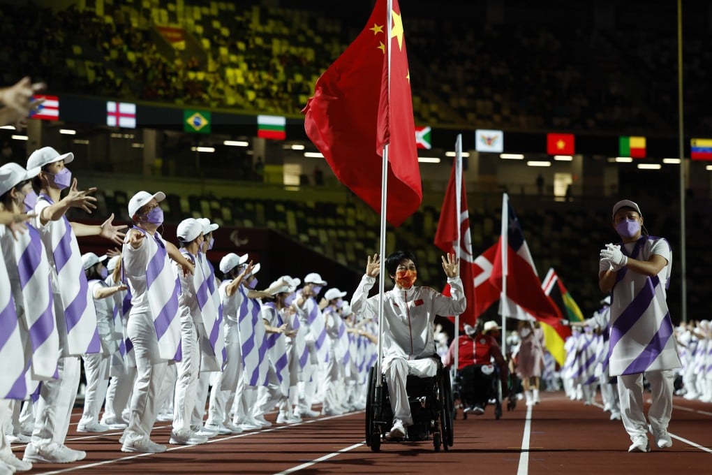 China’s Zhang Xuemei carries the national flag during the closing ceremony of the Tokyo 2020 Paralympic Games. Photo: Reuters