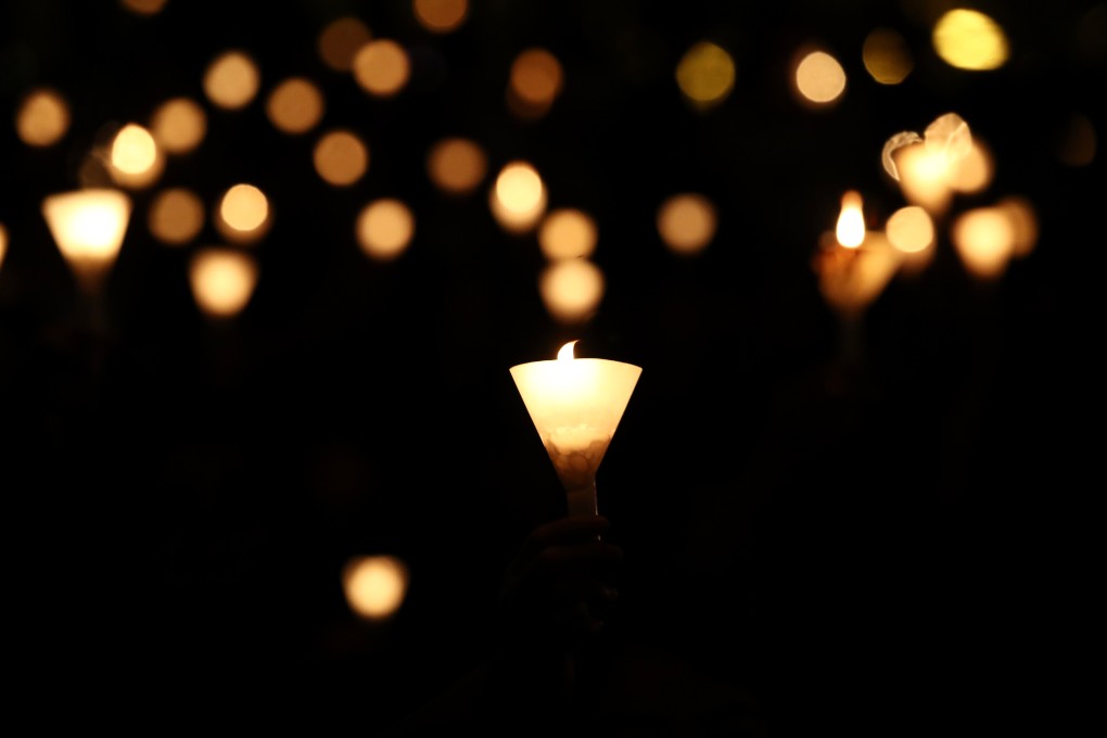 People hold up candles during the June 4 vigil in Victoria Park in Causeway Bay in 2018. Photo: Nora Tam