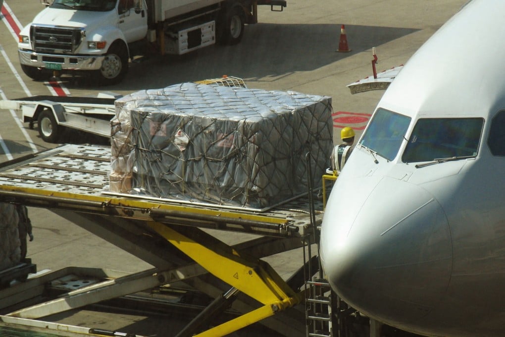Workers unload goods onto a plane at Shanghai Pudong International Airport, which has seen flight cancellations and cargo delays following last month’s coronavirus outbreak. Photo: AFP