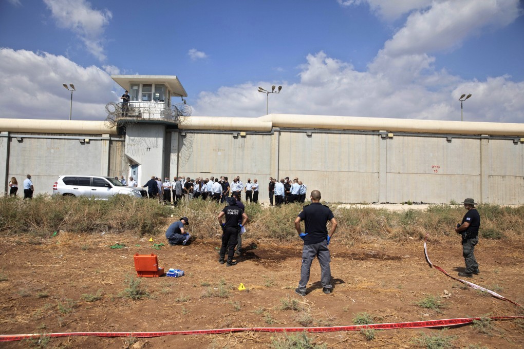 Police officers and prison guards inspect the scene of a prison escape outside the Gilboa prison in Northern Israel on Monday. Photo: AP