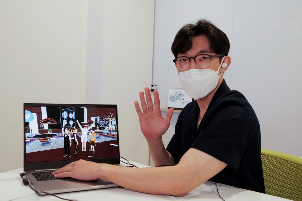 Shaun with a laptop showing his avatar in Decentraland. Photo: Reuters