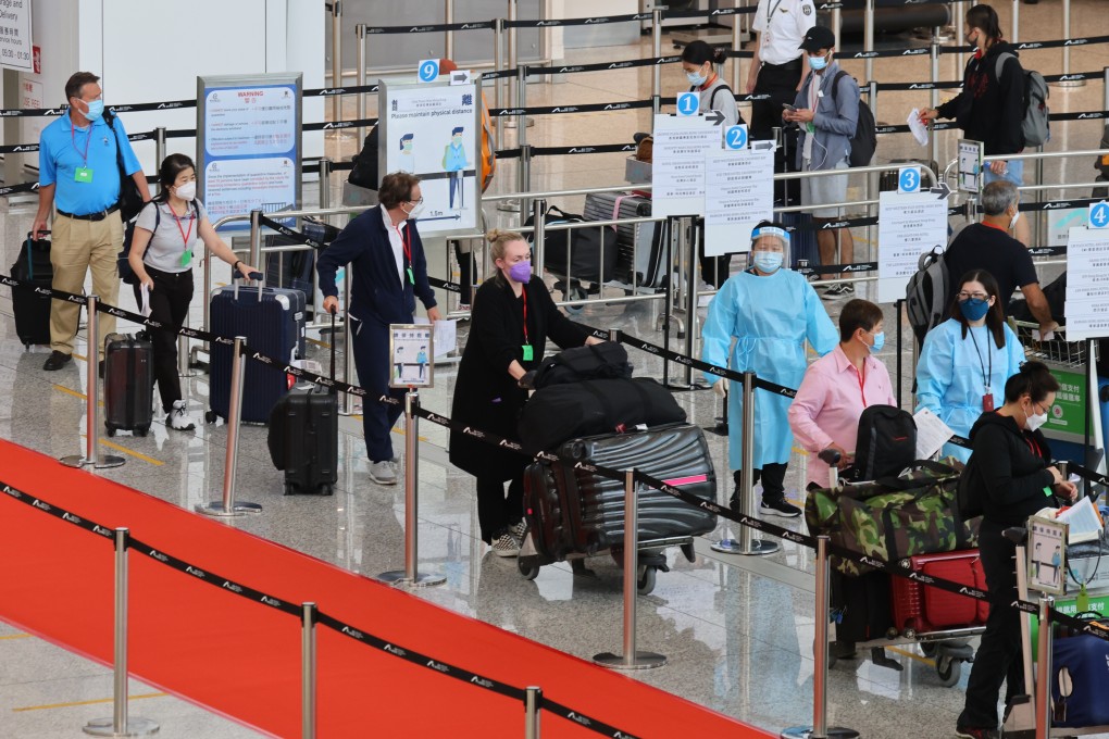 Travellers wait at Hong Kong International Airport to be transported to quarantine hotels in the city. Photo: Dickson Lee