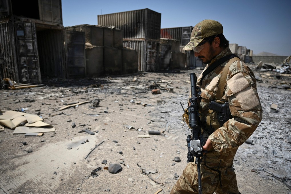 A member of the Taliban special forces walks amid debris of the destroyed CIA base. Photo: AFP