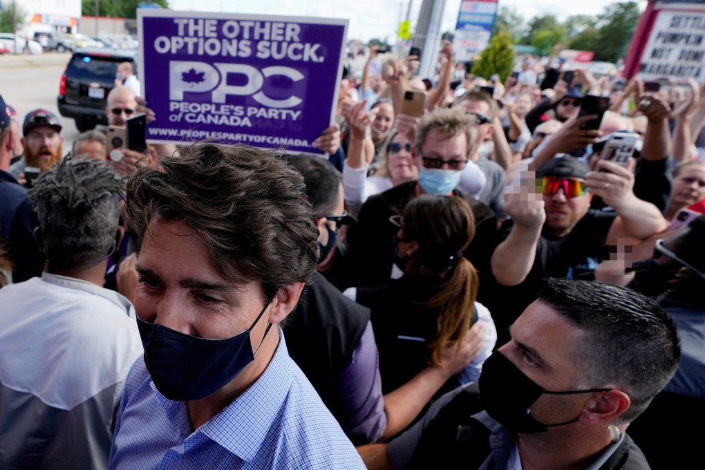 Protesters gesture – some offensively – towards Canada’s Liberal Prime Minister Justin Trudeau at his election campaign tour stop in Brantford, Ontario, on Monday. Photo: Reuters, image edit SCMP