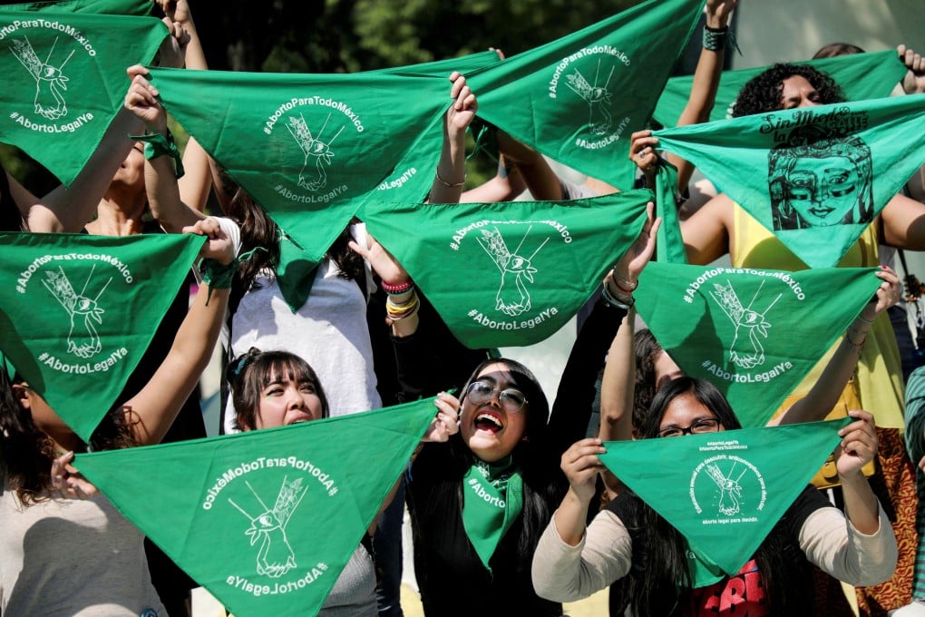 Women hold green handkerchiefs during a protest in support of legal and safe abortion in Mexico City in February 2020. Photo: Reuters