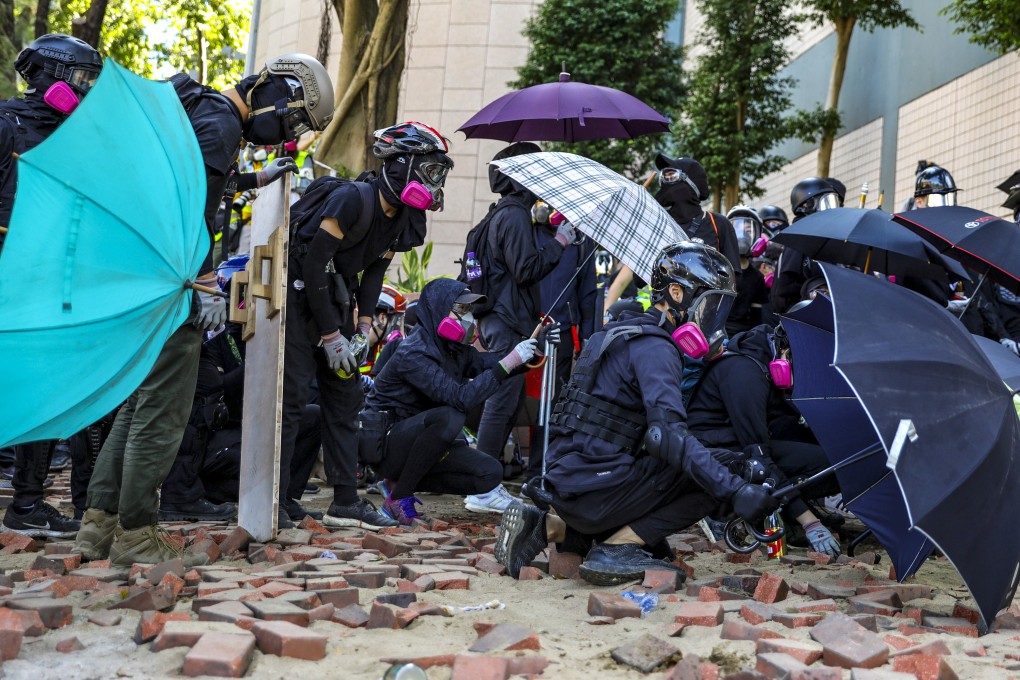 Protesters form a line against police outside Polytechnic University in November, 2019. Photo: May Tse