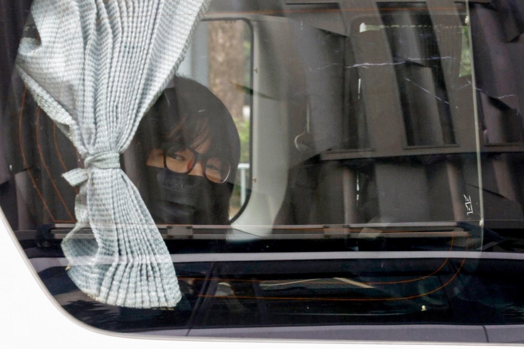 Alliance vice-chairwoman Chow Hang-tung looks through the window of a police vehicle after her arrest on Wednesday morning. Photo: Reuters
