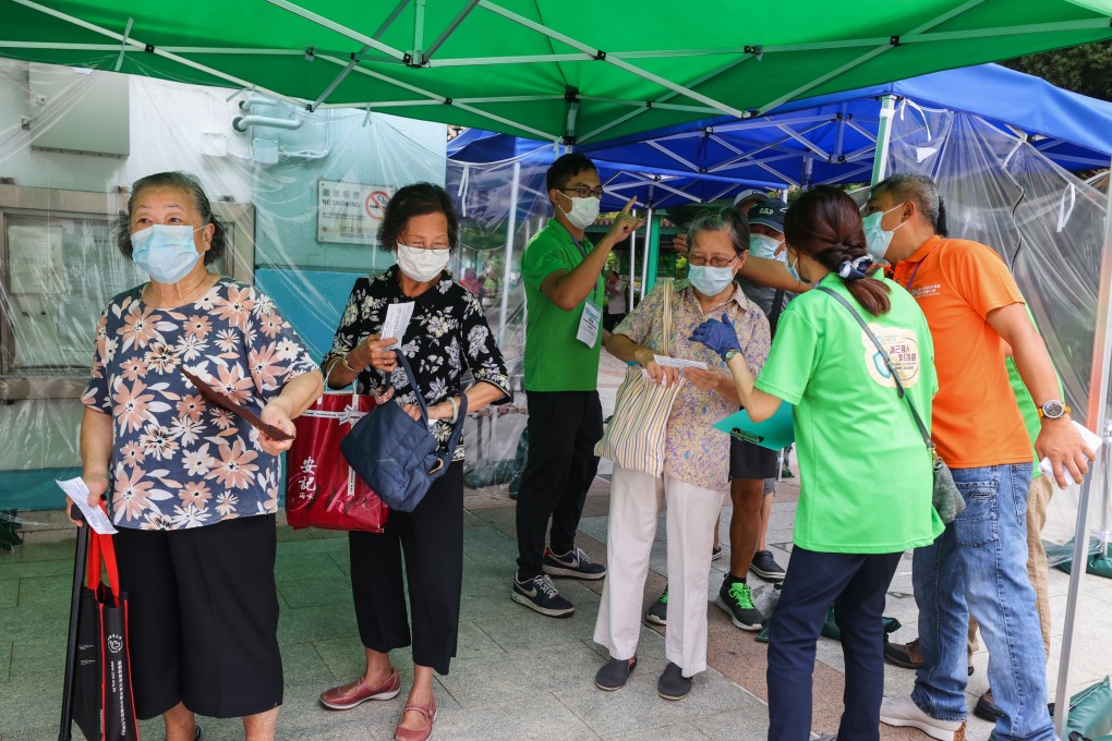Elderly residents queue in Mong Kok on the first day of a scheme providing about 4,600 walk-in slots for those aged 70 and above at 24 of the city’s community vaccination centres. Photo: Dickson Lee