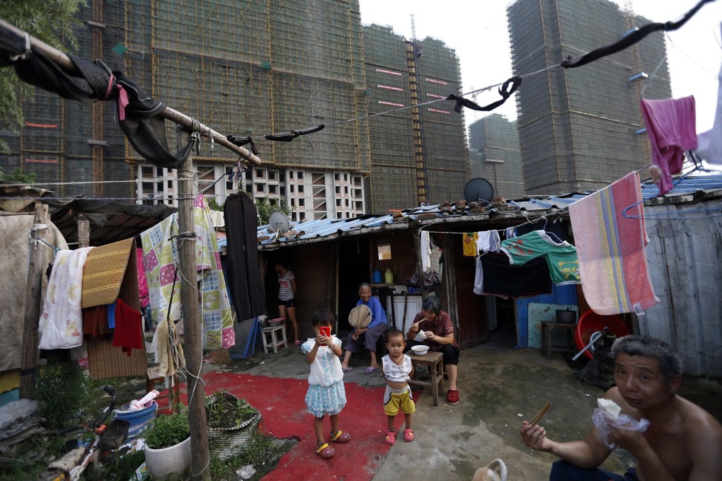 A poor migrant family eats dinner at their makeshift shelter next to a construction site in China’s Zhejiang province, where authorities in July launched a pilot programme designed to achieve common prosperity by 2025. Photo: Reuters