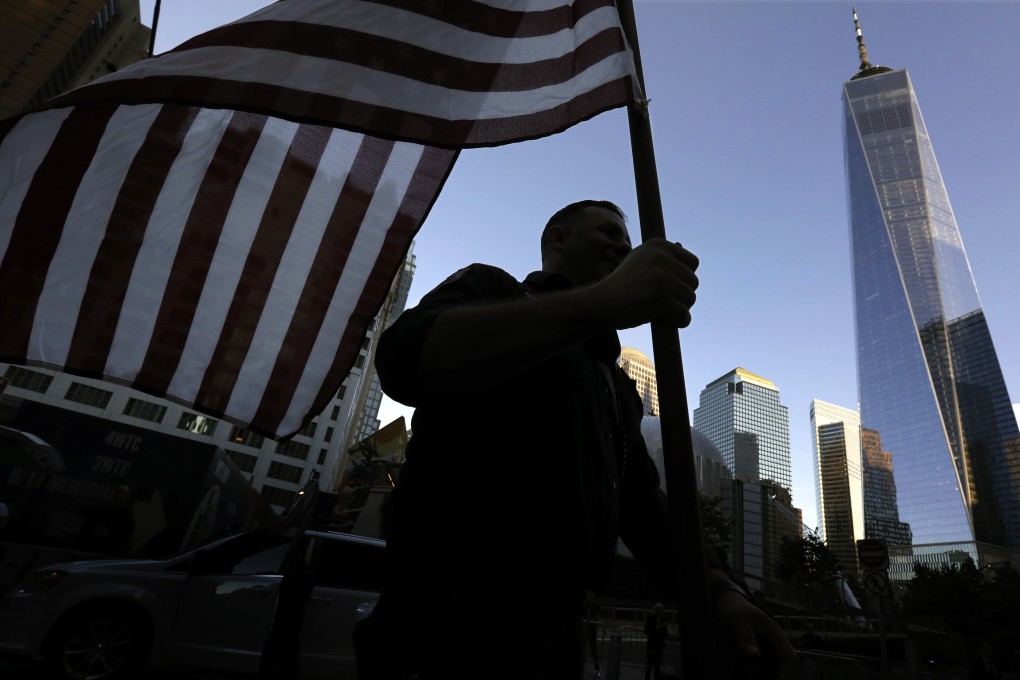 A New York City firefighter carries an American flag on the September 11 anniversary. Photo: EPA