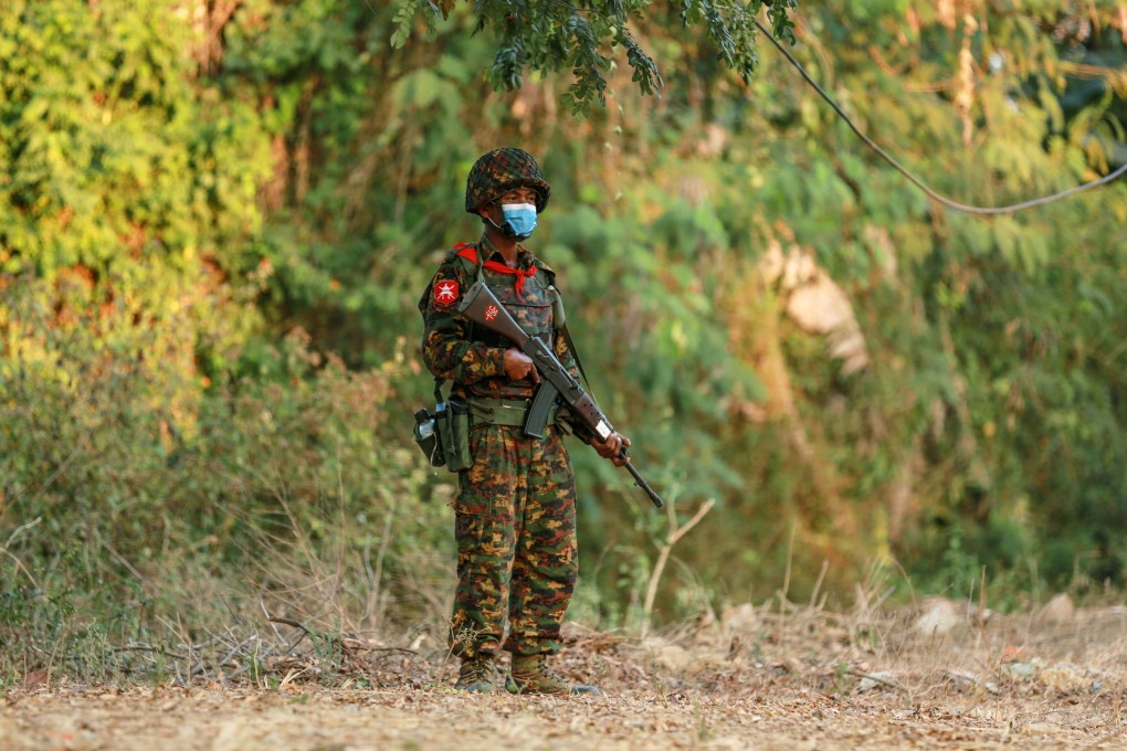 A Myanmar soldier stands guard as fighting escalates in the country. An estimated 1,058 activists and bystanders have been killed since February’s army takeover. Photo: Reuters