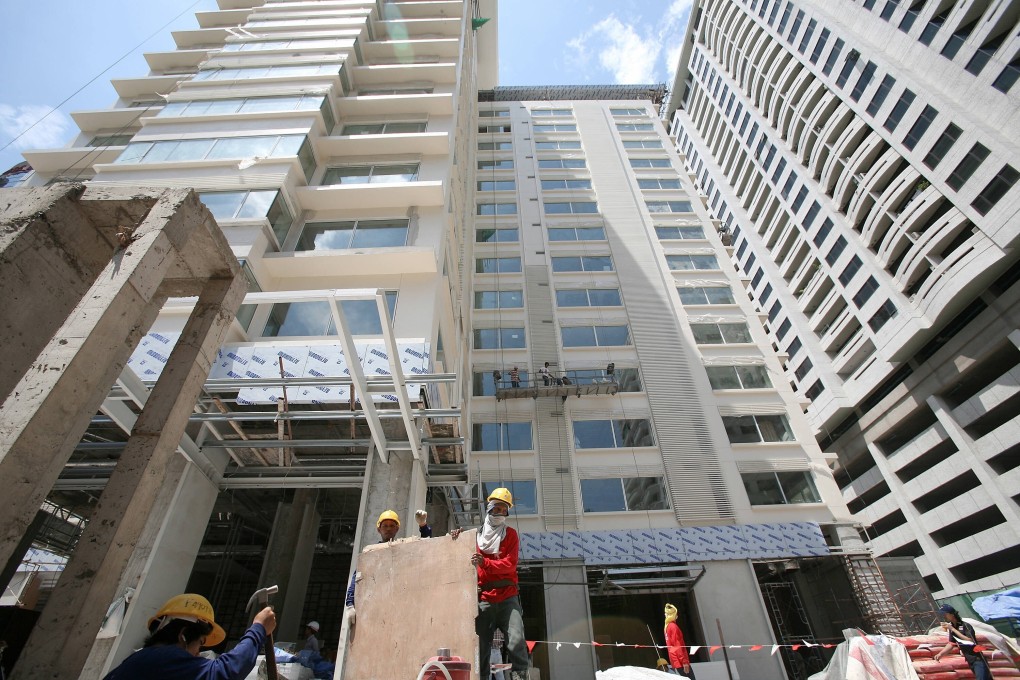 Workers at an apartment project in Bangkok. An economic slump and protests against the military-led government have hurt developers who struggle to shake off a supply glut. Photo: AFP