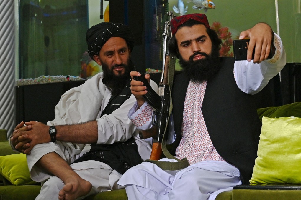 Taliban fighters take a selfie with a mobile phone after seizing the mansion of Afghan warlord Abdul Rashid Dostum. Photo: AFP