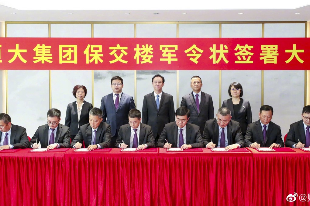 Hui Ka-yan (centre, standing) in an undated signing ceremony with senior executives of China Evergrande, pledging to deliver the projects to customers. Photo: Weibo