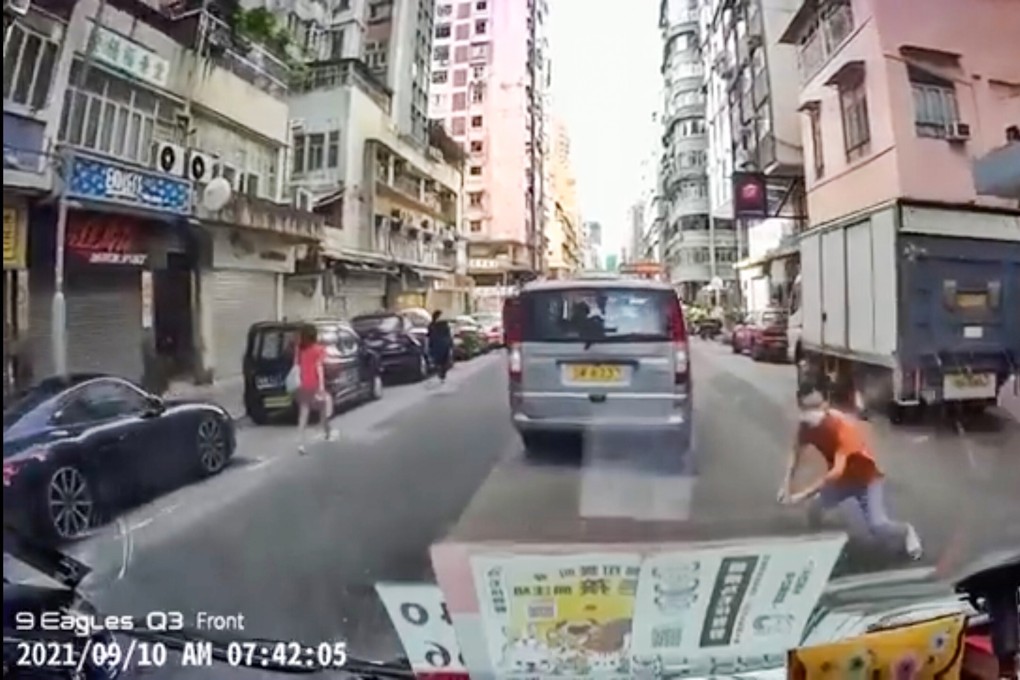 An online video shows a suspected swindler throwing himself in front of a vehicle in Fa Yuen Street in an attempt to extort money from the driver. Photo: Handout