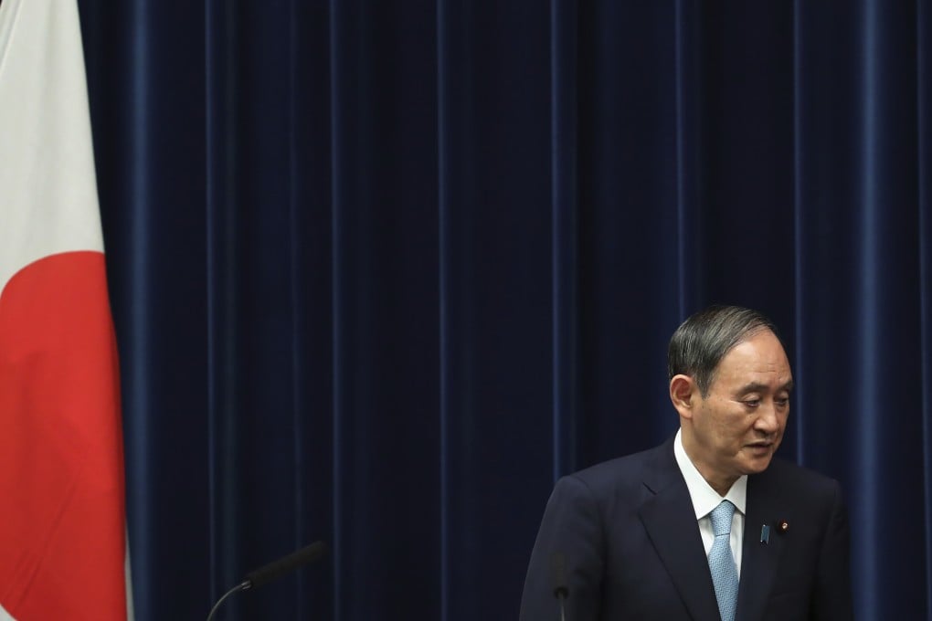 Outgoing Japanese Prime Minister Yoshihide Suga leaves from a news conference at his office in Tokyo after announcing the extension of the coronavirus state of emergency in Tokyo and 18 other areas. Photo: AP