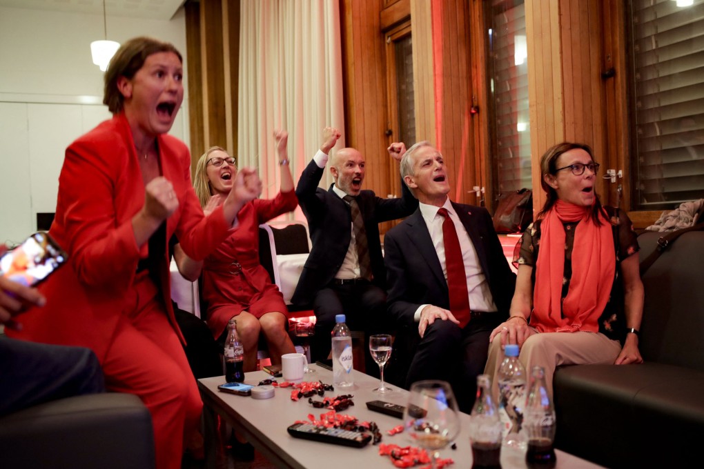 Norway’s Jonas Gahr Store, second right, cheers after seeing the exit poll results of the Labour Party's election event in Folkets Hus, Oslo on Monday. Photo: NTB / AFP
