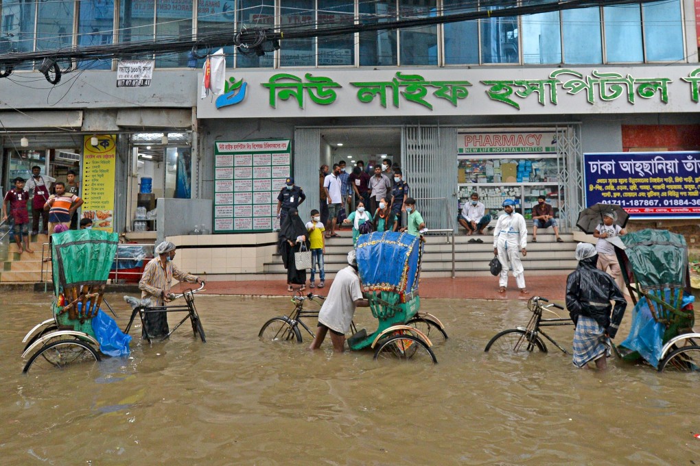 A waterlogged street in Dhaka in July. Bangladesh is particularly affected by flooding and crop failures, accounting for almost half of a World Bank report’s predicted climate migrants. Photo: AFP