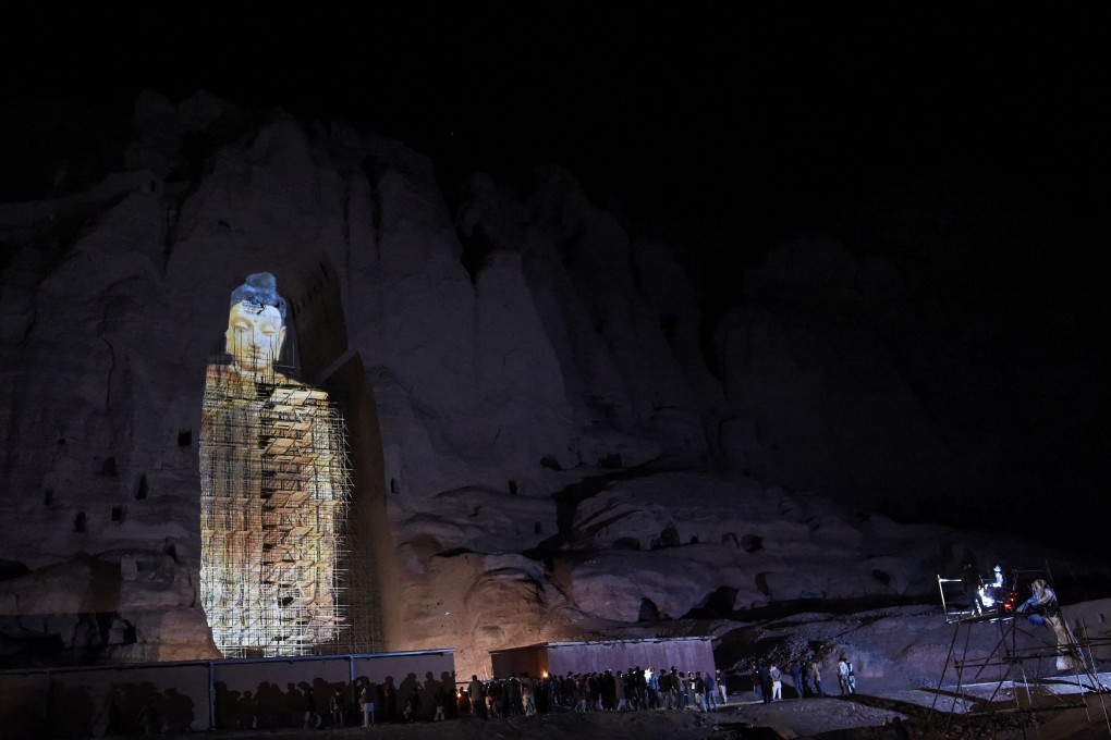 People watch a three-dimensional projection of the Salsal Buddha at the site where the Buddhas of Bamiyan statues stood before being destroyed by the Taliban in March 2001. Photo: AFP