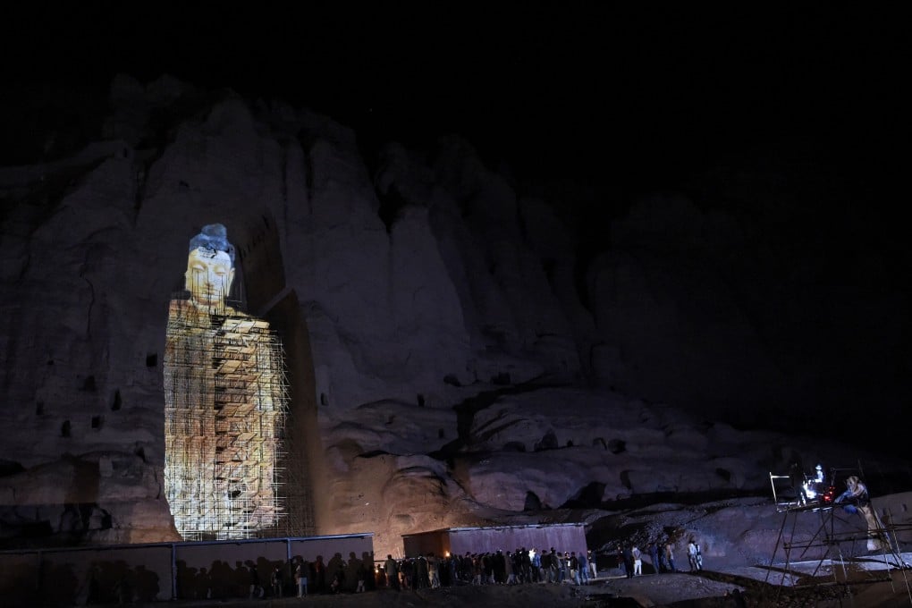 People watch a three-dimensional projection of the Salsal Buddha at the site where the Buddhas of Bamiyan statues stood before being destroyed by the Taliban in March 2001. Photo: AFP