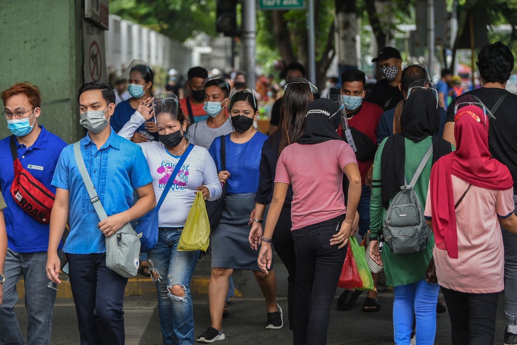 People cross a street in Manila after authorities lifted a stay-at-home order amid record infections fuelled by the contagious Delta variant. Photo: AFP
