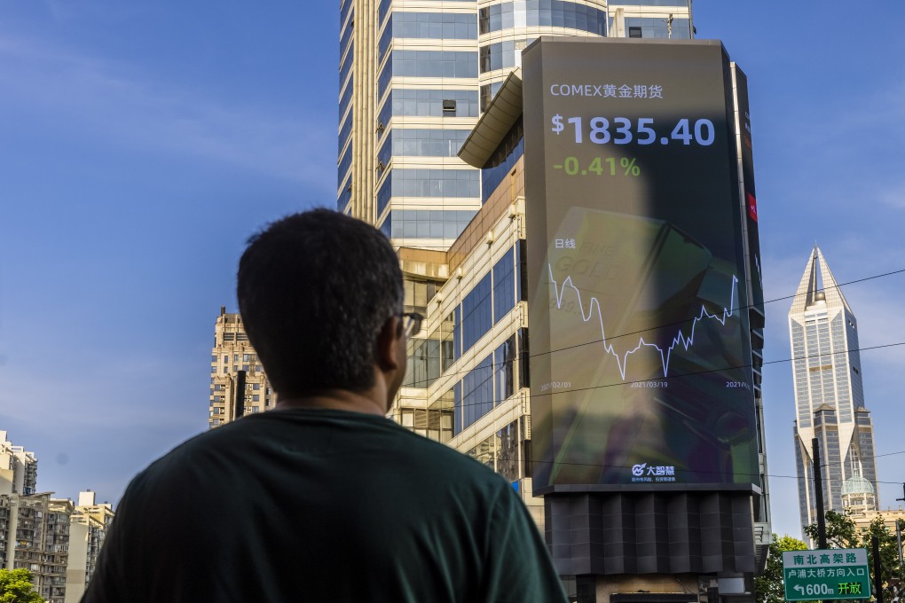 A man observing a large screen showing stock market data in Shanghai in May 2021. Photo: EPA-EFE