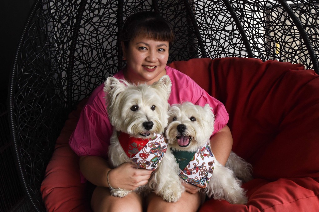 Carrie Er with her pet white terriers Sasha and Piper at her home in Singapore. Photo: AFP