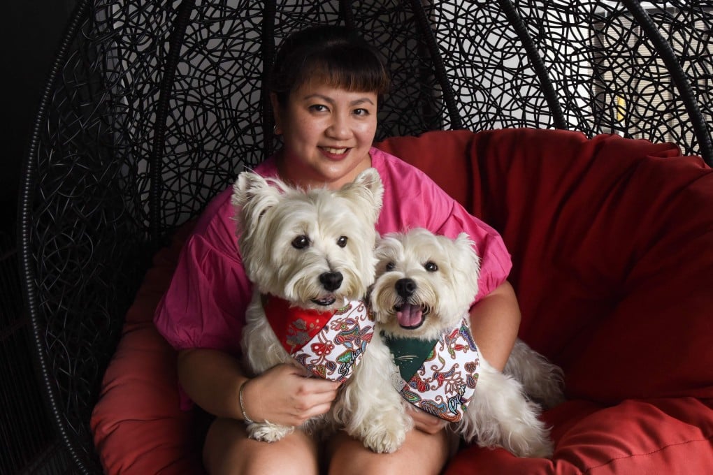 Carrie Er with her pet white terriers Sasha and Piper at her home in Singapore. Photo: AFP