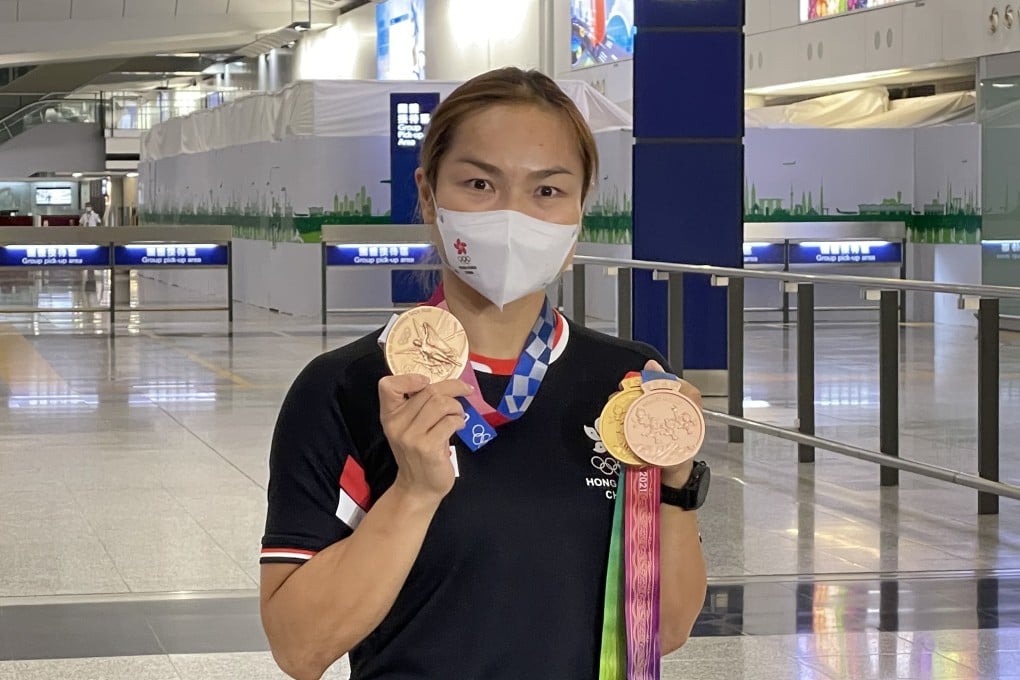 Track cycling star Sarah Lee returns home after a two-month campaign, which included the Tokyo Olympic Games and the National Games. Photo: Chan Kin-wa