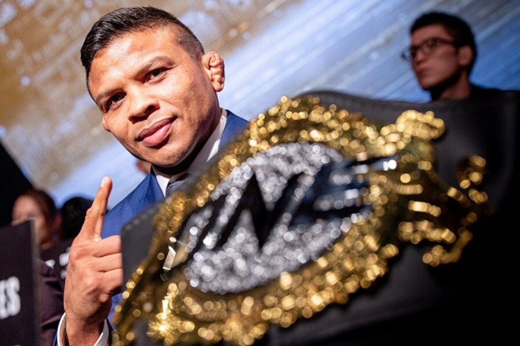 Bibiano Fernandes with his title at a ONE press conference. Photo: ONE Championship