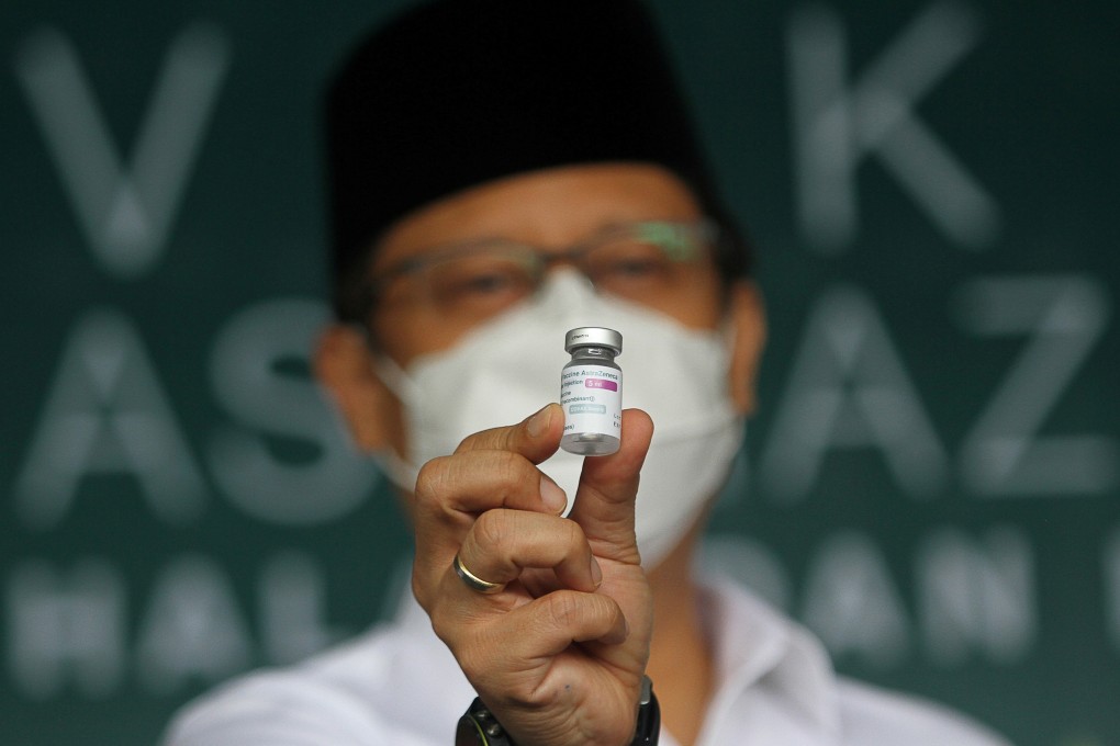 Indonesian Health Minister Budi Gunadi Sadikin shows off an AstraZeneca coronavirus vaccine vial at a mass vaccination programme in Surabaya. Photo: Reuters