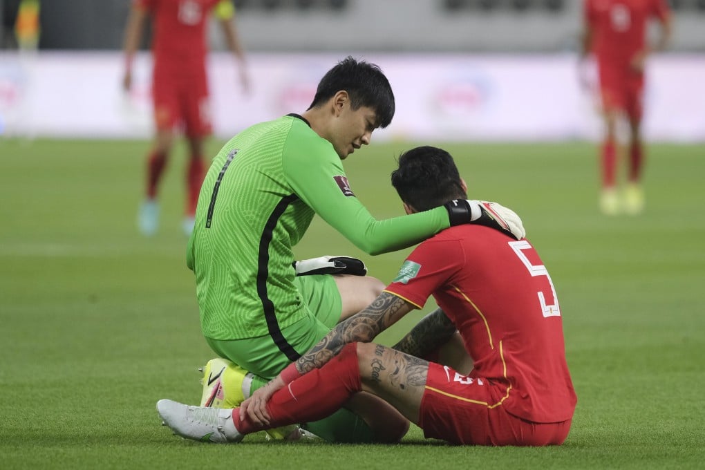 China goalkeeper Yan Junling comforts his teammate Zhang Linpeng in their Fifa World Cup Qatar 2022 Asian qualification football match against Japan. Photo: Xinhua