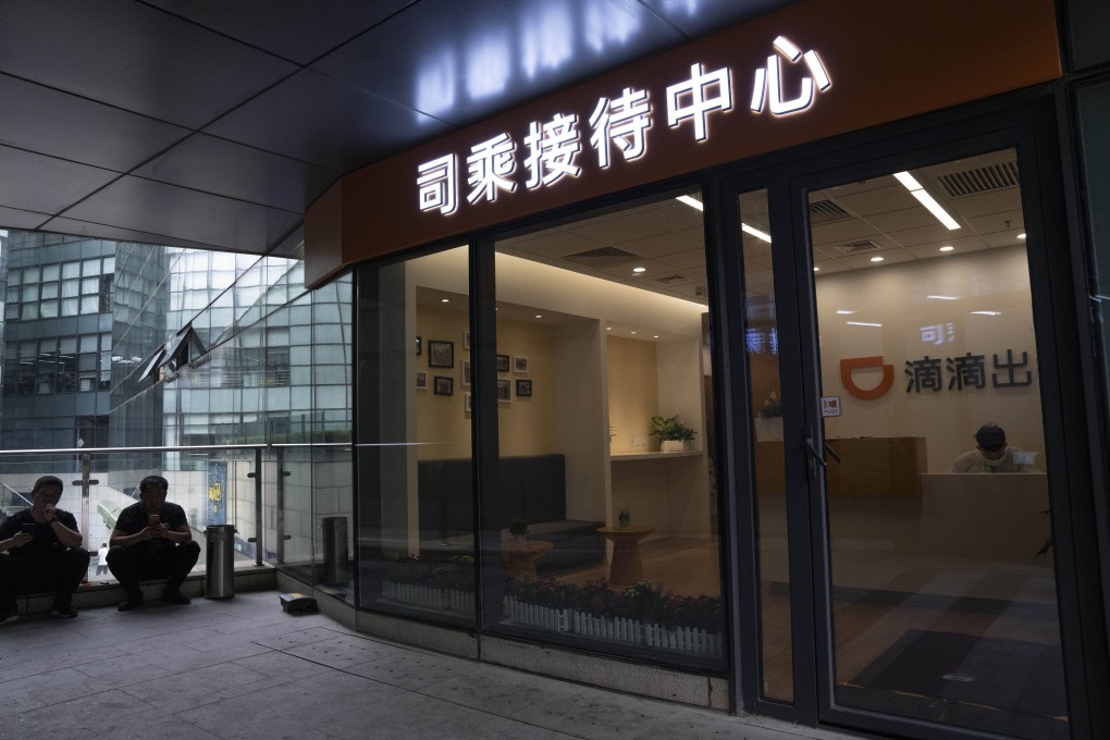 Men wait outside a centre for drivers of ride-hailing giant Didi Chuxing in Beijing on July 16, 2021. Didi’s average daily active users decreased to 10.9 million in August from 15.6 million in June. Photo: AP