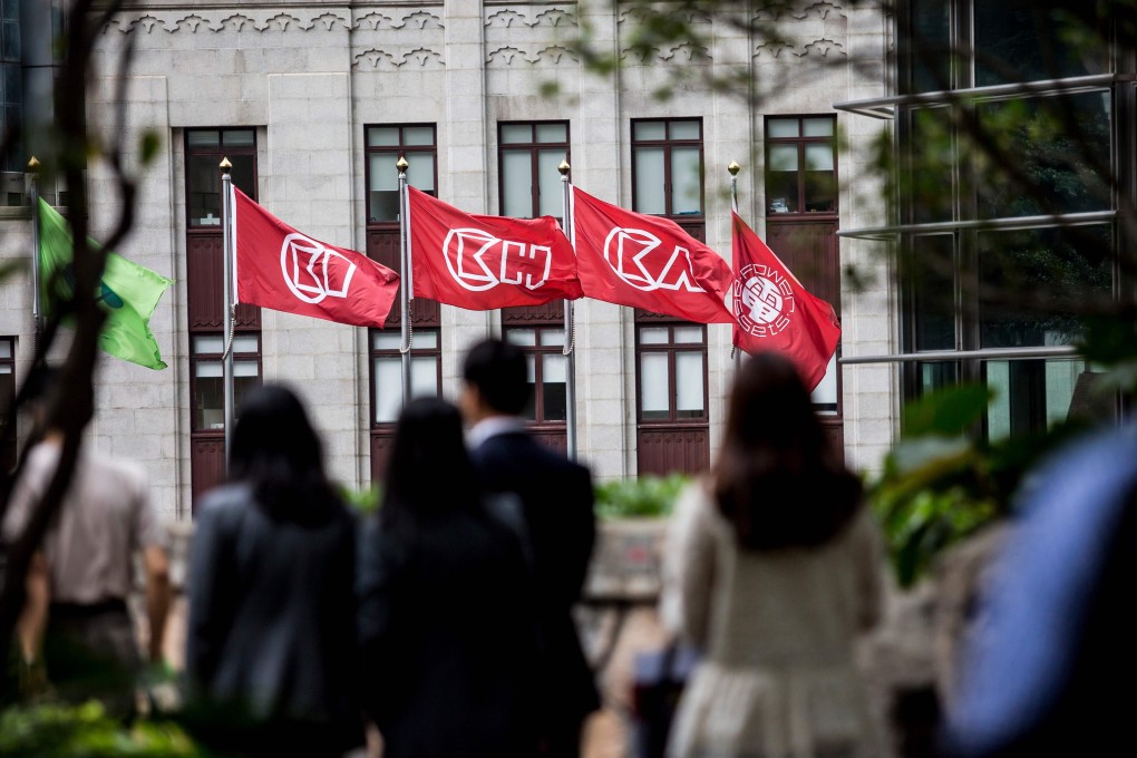 People seen outside the headquarters of CK Hutchison in Hong Kong. Photo: AFP