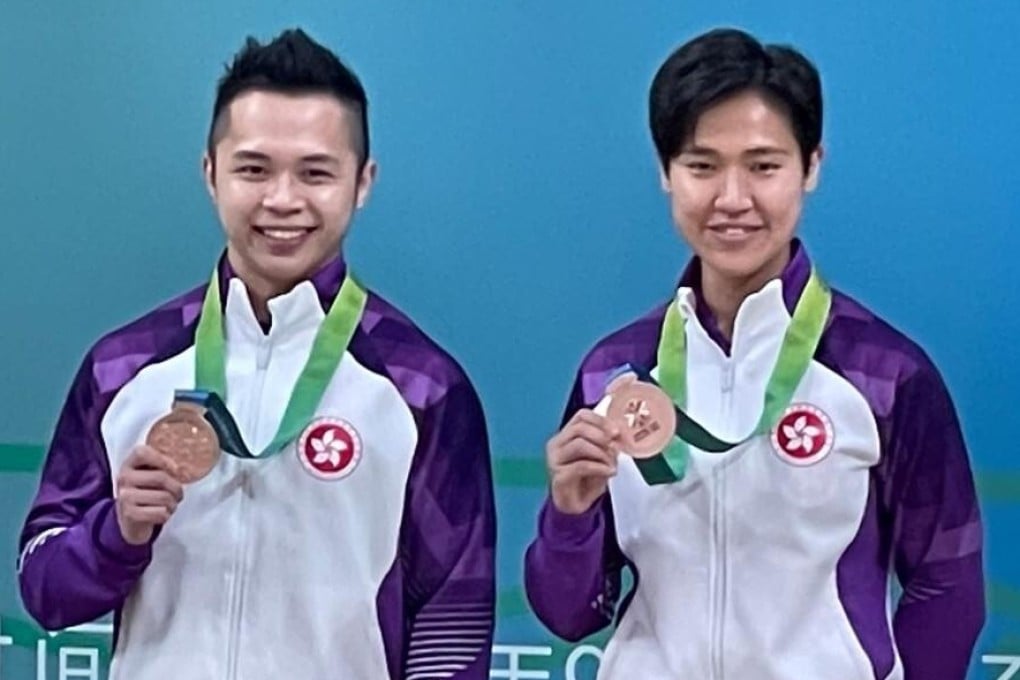 Lau Chi-ming celebrates his bronze in men's kata with coach Li Pui-ki. Photo: The Karatedo Federation of Hong Kong