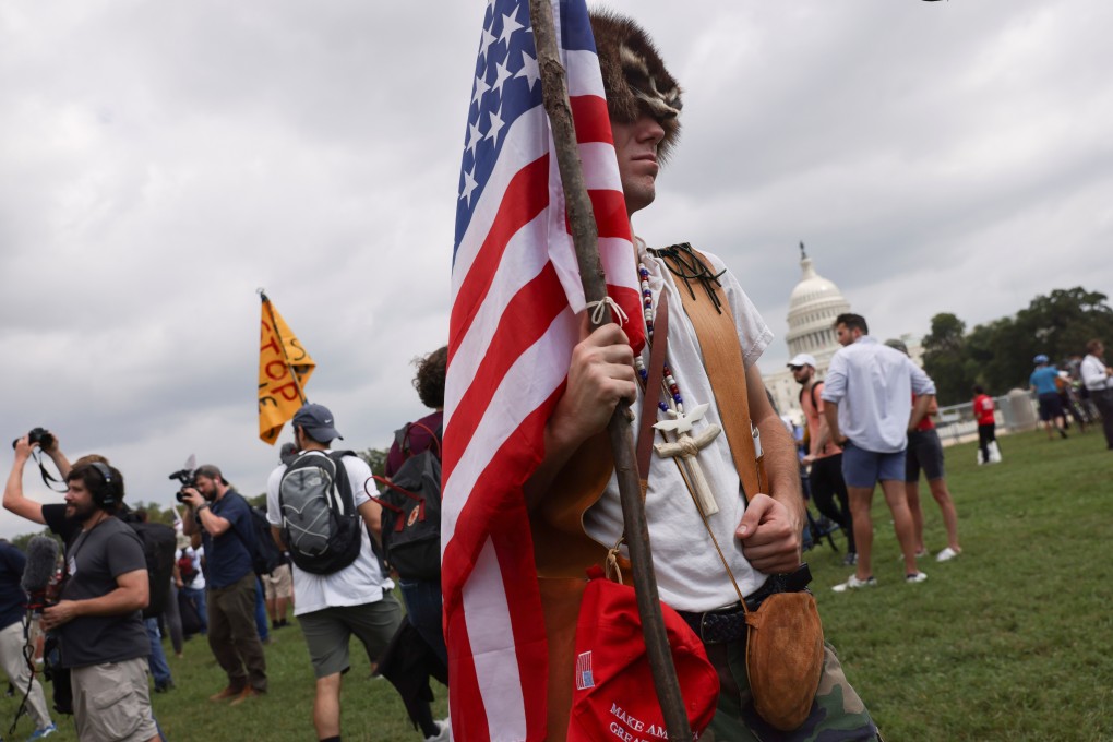 A demonstrator carrying a US flag takes part in a rally near the US Capitol on Saturday. Photo: Reuters