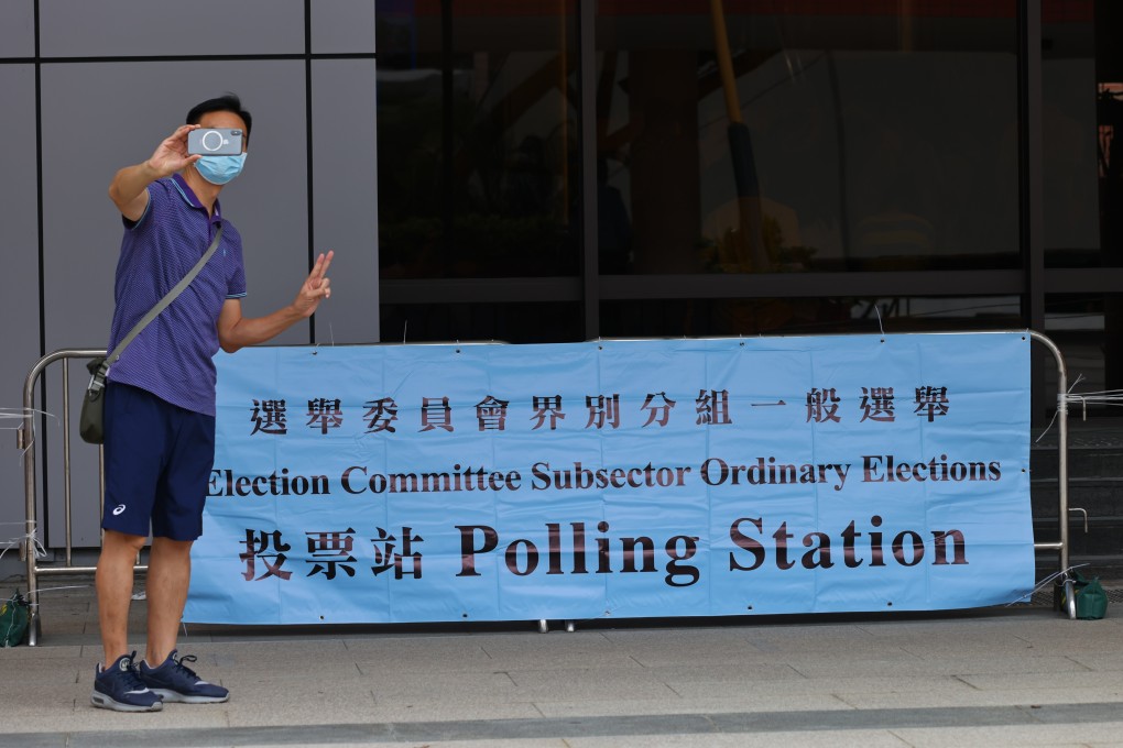 A man takes a selfie next to an election banner outside the polling station in Sha Tin Town Hal. Photo: Dickson Lee
